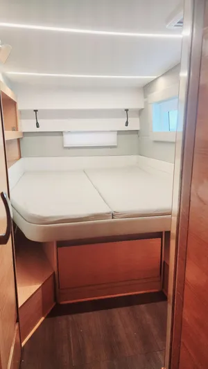 Nauti By Nature Yacht Photos Pics Interior cabin of 2017 Nautitech 46 Fly catamaran with bed and wooden finishes.