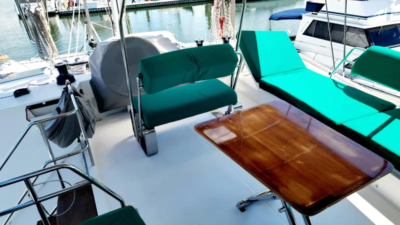 Nauti By Nature Yacht Photos Pics Nautitech 46 Fly 2017 yacht deck with green seating and wooden table.