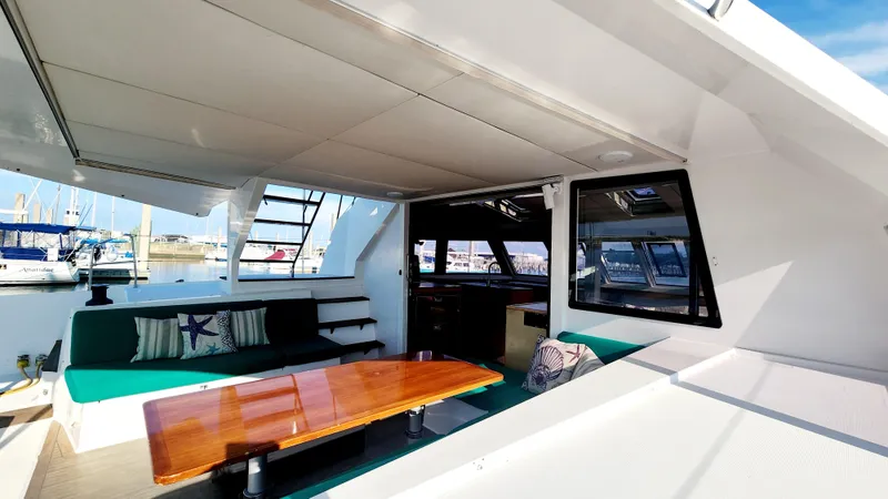 Nauti By Nature Yacht Photos Pics Spacious interior of 2017 Nautitech 46 Fly catamaran with comfortable seating and wooden table.
