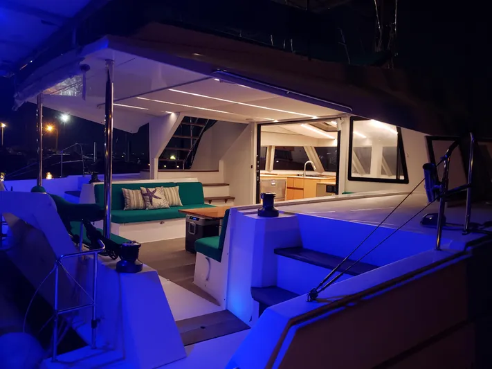 Nauti By Nature Yacht Photos Pics Luxurious Nautitech 46 Fly catamaran interior at night, featuring elegant seating and ambient lighting.