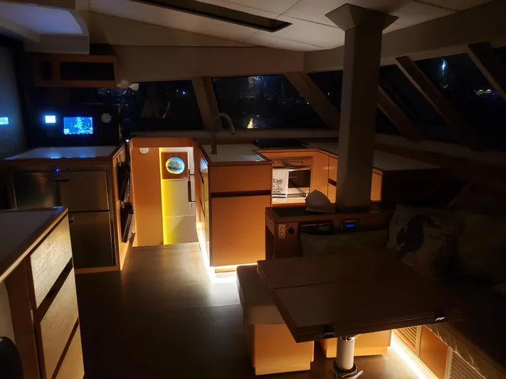 Nauti By Nature Yacht Photos Pics Interior of 2017 Nautitech 46 Fly catamaran, featuring modern kitchen and dining area at night.