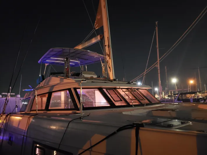Nauti By Nature Yacht Photos Pics 2017 Nautitech 46 Fly catamaran docked at night, illuminated by marina lights.