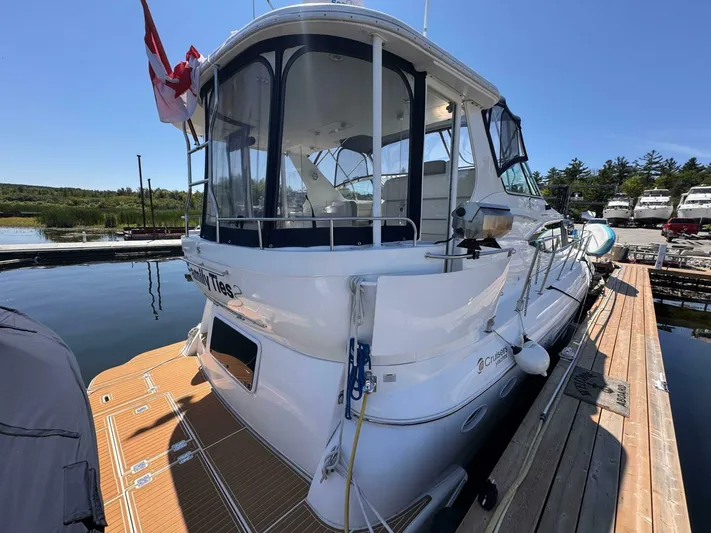  Yacht Photos Pics 2002 Cruisers Yachts 4450 Express Motor Yacht docked at marina under clear blue sky.