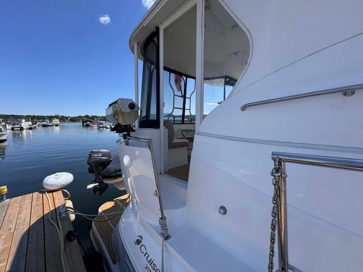  Yacht Photos Pics 2002 Cruisers Yachts 4450 Express Motor Yacht docked at marina, clear sky, calm water.
