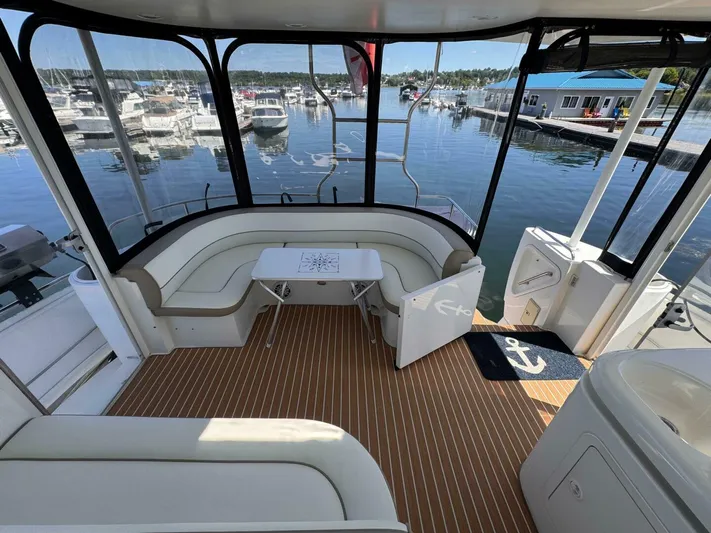  Yacht Photos Pics 2002 Cruisers Yachts 4450 Express Motor Yacht interior with marina view.