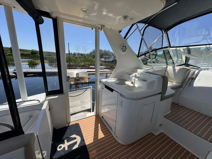  Yacht Photos Pics 2002 Cruisers Yachts 4450 Express Motor Yacht interior with seating and water view.