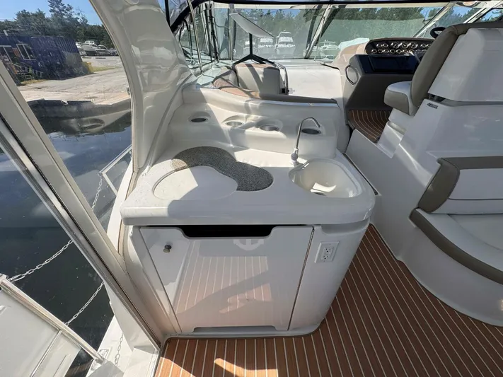  Yacht Photos Pics 2002 Cruisers Yachts 4450 Express Motor Yacht interior with sink and seating area.