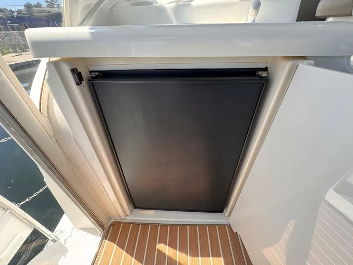  Yacht Photos Pics 2002 Cruisers Yachts 4450 Express Motor Yacht interior detail with black panel and striped flooring.