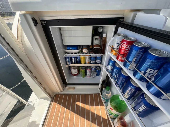  Yacht Photos Pics Open fridge on 2002 Cruisers Yachts 4450 Express, stocked with beverages and drinks.