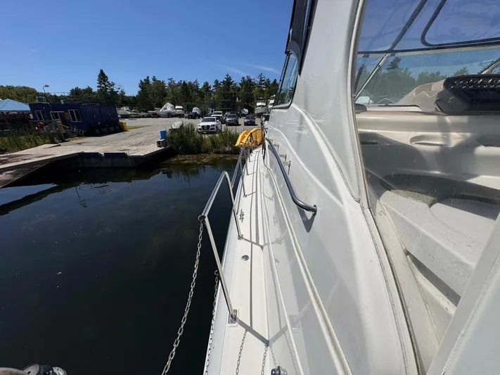  Yacht Photos Pics 2002 Cruisers Yachts 4450 Express Motor Yacht docked at marina under clear blue sky.