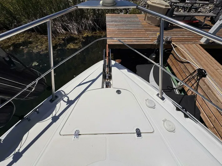  Yacht Photos Pics 2002 Cruisers Yachts 4450 Express Motor Yacht bow view at dock.