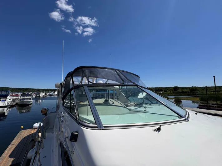  Yacht Photos Pics 2002 Cruisers Yachts 4450 Express Motor Yacht docked under clear blue sky.