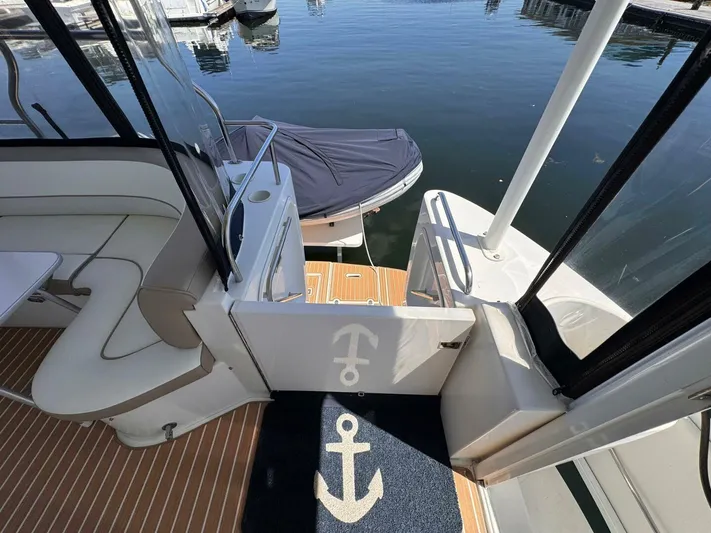  Yacht Photos Pics 2002 Cruisers Yachts 4450 Express Motor Yacht interior with dock view and anchor-themed decor.