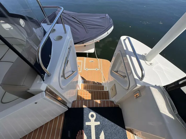  Yacht Photos Pics 2002 Cruisers Yachts 4450 Express Motor Yacht deck with steps and railing, overlooking water.