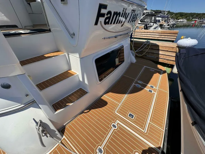  Yacht Photos Pics 2002 Cruisers Yachts 4450 Express Motor Yacht docked, featuring teak deck and steps.