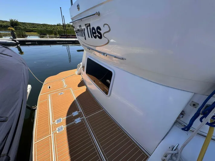  Yacht Photos Pics 2002 Cruisers Yachts 4450 Express Motor Yacht docked with teak deck.