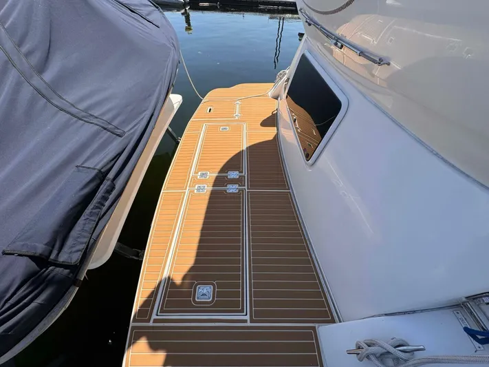  Yacht Photos Pics 2002 Cruisers Yachts 4450 Express Motor Yacht docked with teak deck.