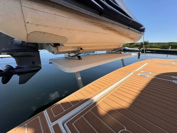  Yacht Photos Pics 2002 Cruisers Yachts 4450 Express Motor Yacht on water, showcasing swim platform and outboard motor.