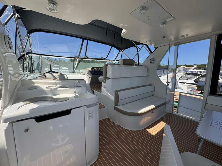  Yacht Photos Pics 2002 Cruisers Yachts 4450 Express Motor Yacht interior with seating and helm.