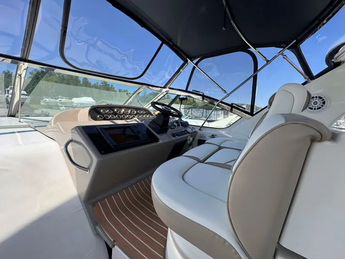  Yacht Photos Pics 2002 Cruisers Yachts 4450 Express Motor Yacht cockpit with modern controls and seating.