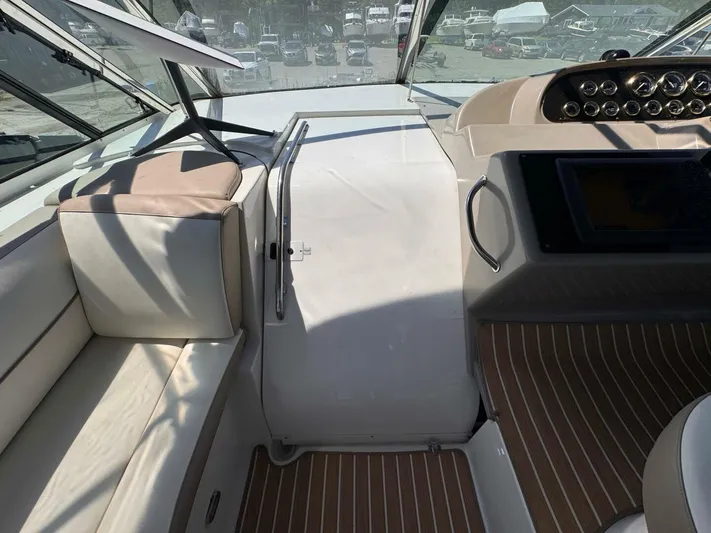  Yacht Photos Pics 2002 Cruisers Yachts 4450 Express Motor Yacht cockpit with seating and control panel.