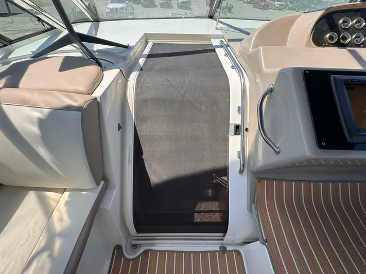  Yacht Photos Pics 2002 Cruisers Yachts 4450 Express Motor Yacht helm area with seating and controls.