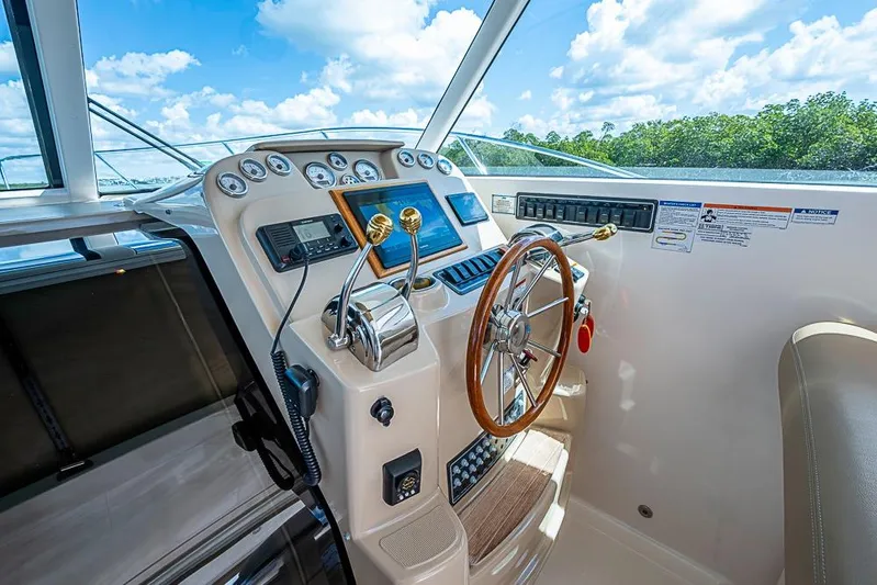Float Me Alone Too Yacht Photos Pics Helm of 2012 Tiara Yachts 3100 Coronet with steering wheel and control panel.