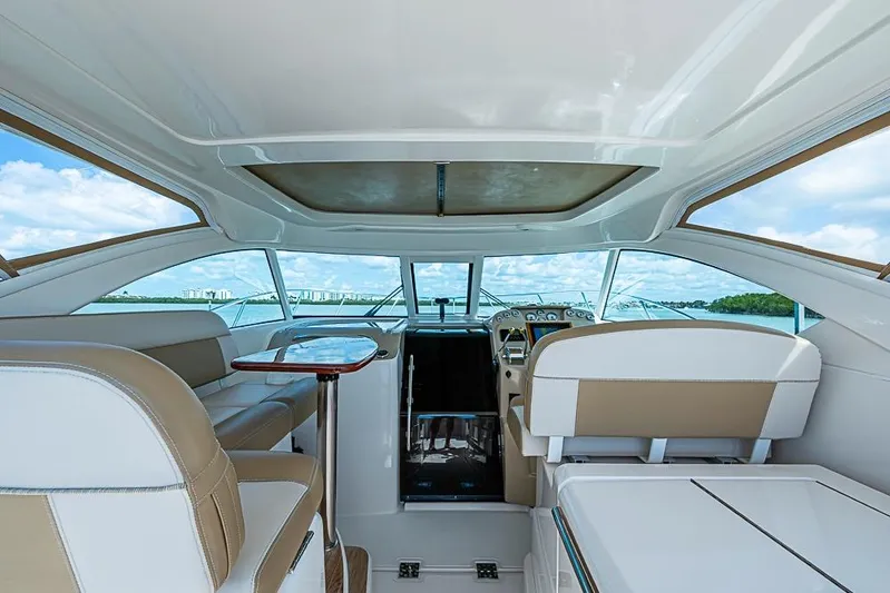 Float Me Alone Too Yacht Photos Pics Interior view of 2012 Tiara Yachts 3100 Coronet, featuring luxurious seating and helm.