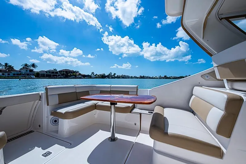 Float Me Alone Too Yacht Photos Pics Luxurious seating area on a 2012 Tiara Yachts 3100 Coronet, overlooking serene waters.