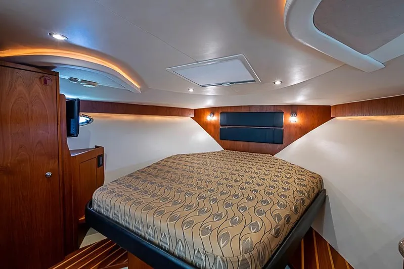 Float Me Alone Too Yacht Photos Pics Luxurious cabin interior of 2012 Tiara Yachts 3100 Coronet with elegant bedding and wood accents.