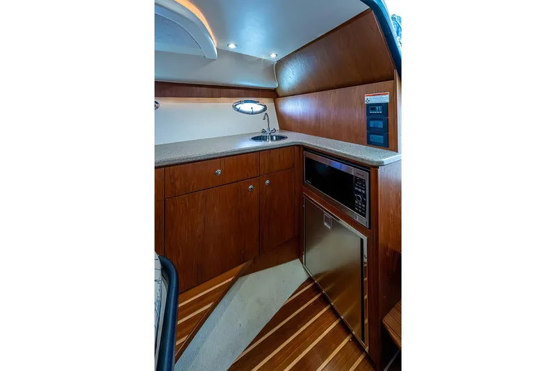 Float Me Alone Too Yacht Photos Pics 2012 Tiara Yachts 3100 Coronet interior kitchen with wood cabinetry and modern appliances.