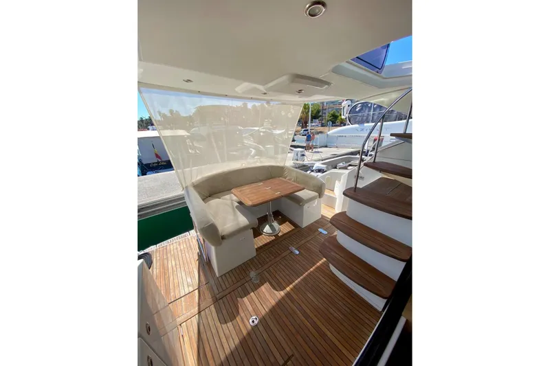 Yacht Photos Pics Luxurious 2011 Beneteau Monte Carlo 47 Fly yacht interior with elegant seating and wooden flooring.