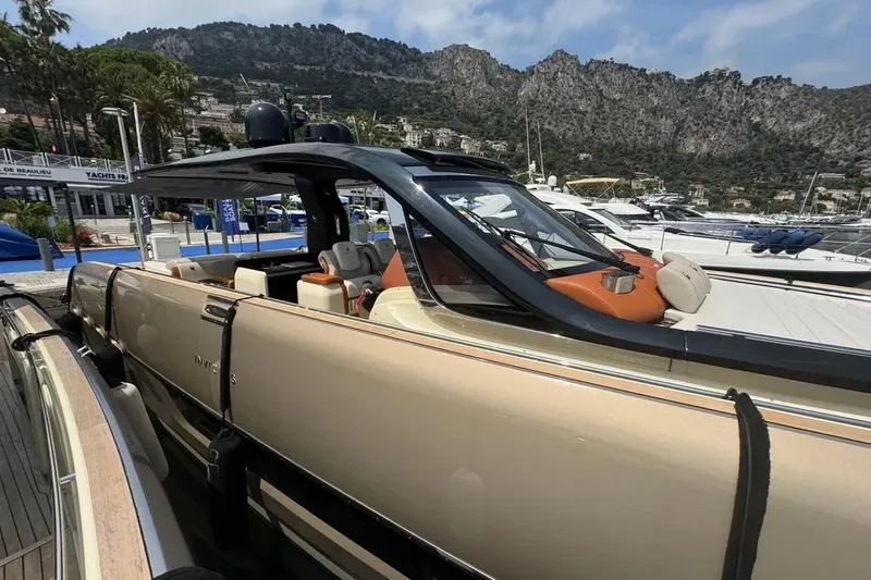  Yacht Photos Pics 2024 Invictus TT460 luxury yacht docked at marina with scenic mountain backdrop.
