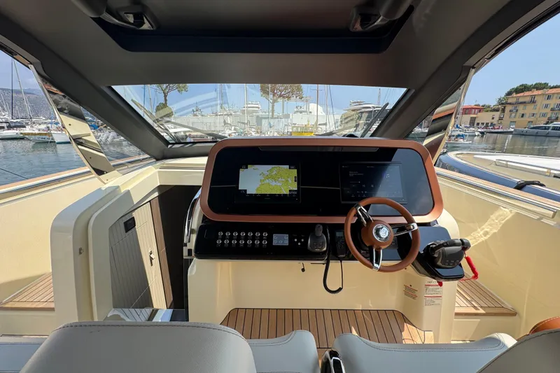  Yacht Photos Pics 2024 Invictus TT460 yacht cockpit with modern navigation system and luxurious steering wheel.