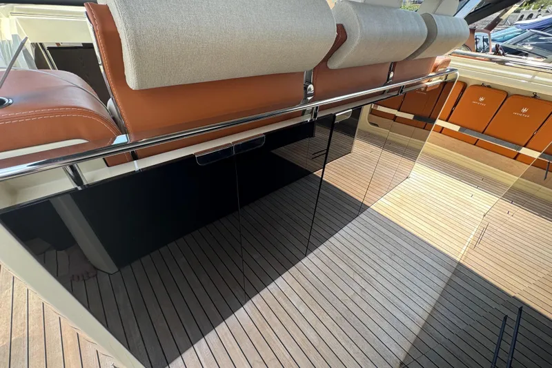  Yacht Photos Pics 2024 Invictus TT460 yacht interior with sleek seating and polished wood flooring.