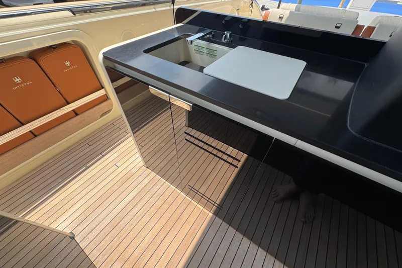  Yacht Photos Pics Luxurious 2024 Invictus TT460 yacht interior with sleek kitchen and elegant wood flooring.