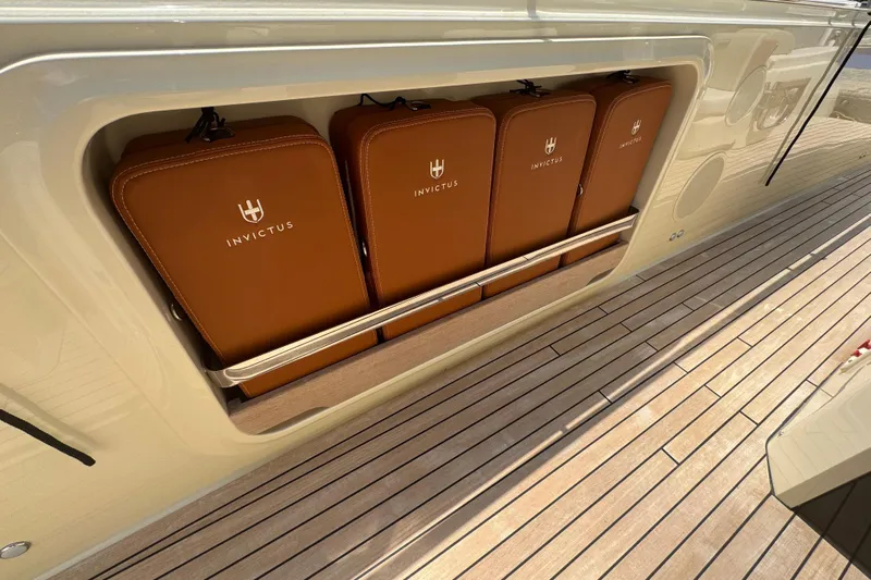  Yacht Photos Pics 2024 Invictus TT460 yacht storage compartment with branded leather cases on teak deck.