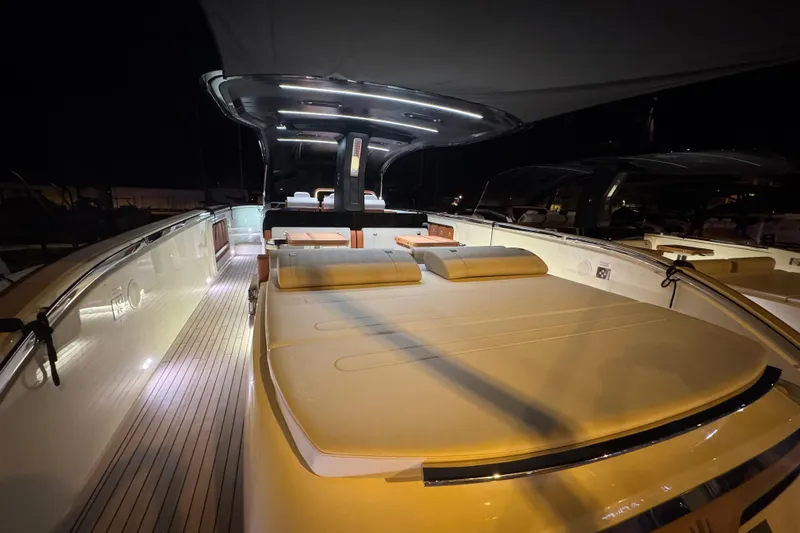  Yacht Photos Pics 2024 Invictus TT460 yacht interior with elegant lighting and luxurious seating at night.