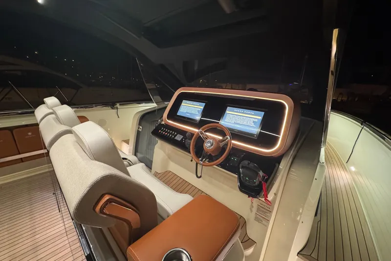  Yacht Photos Pics Luxurious 2024 Invictus TT460 yacht cockpit with modern dashboard and elegant seating.