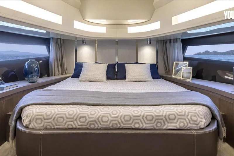  Yacht Photos Pics Luxurious 2024 Invictus TT460 yacht bedroom with elegant decor and panoramic windows.