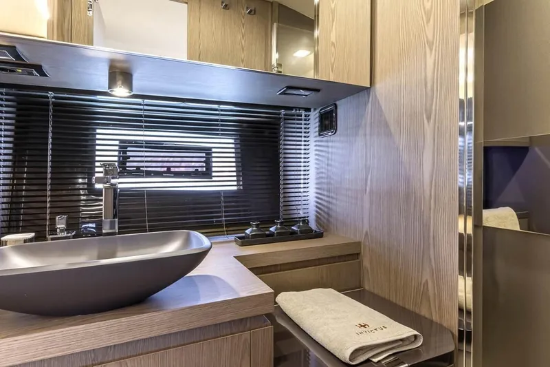  Yacht Photos Pics Luxurious bathroom interior of 2024 Invictus TT460 yacht with modern sink and wooden finishes.