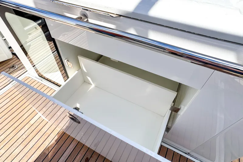  Yacht Photos Pics Open storage compartment on 2025 Wellcraft 38 Explorer yacht with wooden deck.