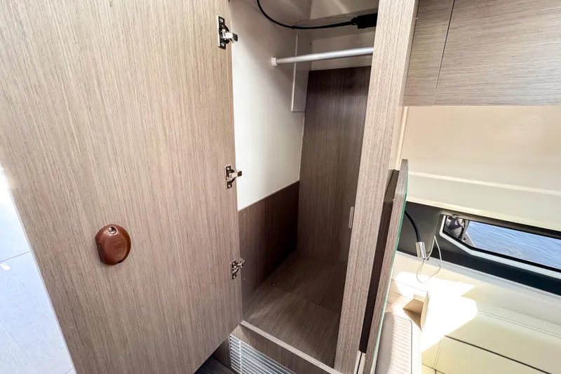  Yacht Photos Pics Interior closet of 2025 Wellcraft 38 Explorer boat, featuring modern wood finish.