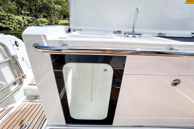  Yacht Photos Pics 2025 Wellcraft 38 Explorer boat deck with sleek design and stainless steel railing.