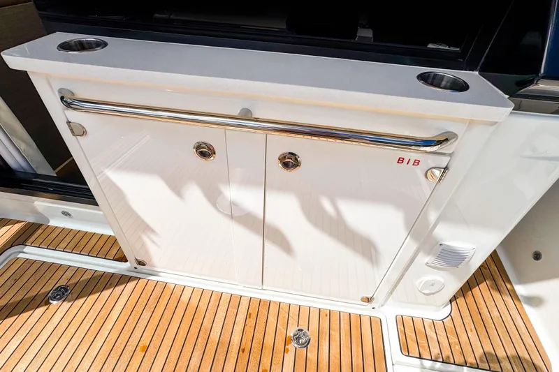  Yacht Photos Pics 2025 Wellcraft 38 Explorer yacht deck with storage cabinet and cup holders.