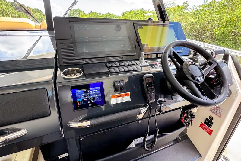  Yacht Photos Pics Helm of 2025 Wellcraft 38 Explorer with advanced navigation displays and controls.