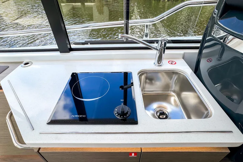  Yacht Photos Pics Modern kitchen area on 2025 Wellcraft 38 Explorer yacht with stove and sink.