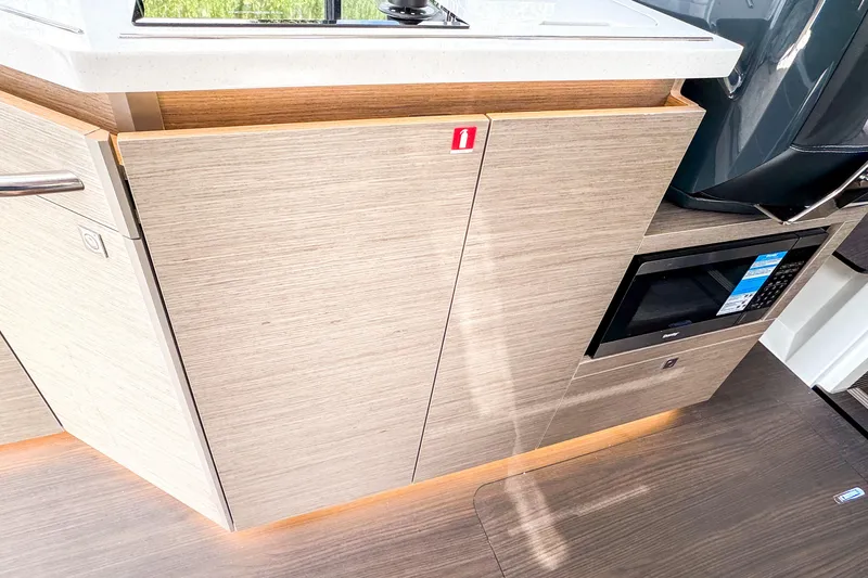  Yacht Photos Pics Modern kitchen area in 2025 Wellcraft 38 Explorer boat with wood cabinetry and microwave.