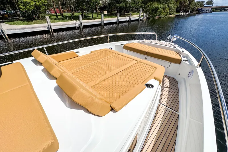  Yacht Photos Pics Luxurious 2025 Wellcraft 38 Explorer boat with tan cushioned deck seating.