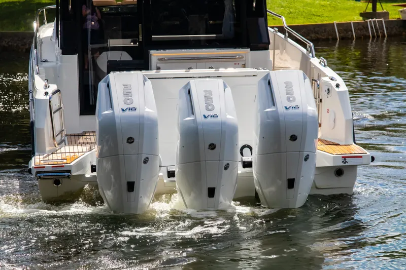  Yacht Photos Pics 2025 Wellcraft 38 Explorer with triple outboard engines on water.